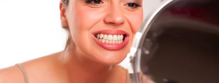 Looking At Teeth In Mirror To See If It'S Time To See A Dentist