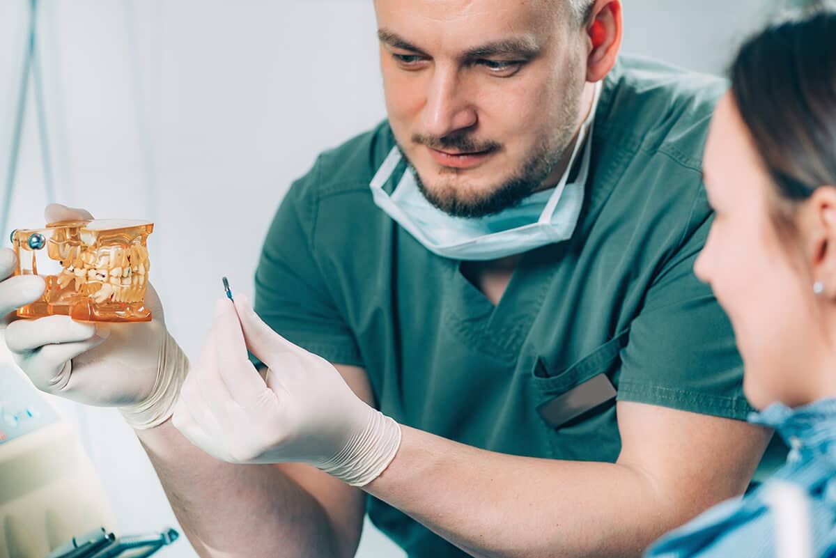 Dentist Explaining Dental Implant Procedure To Pat