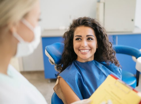 A Woman Smiling With A Set Of White Teeth