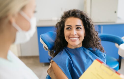 A Woman Smiling With A Set Of White Teeth