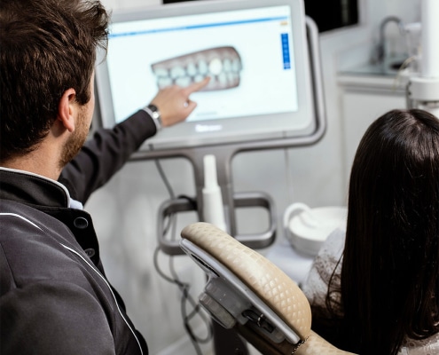 Dentist Reviewing Image With Patient