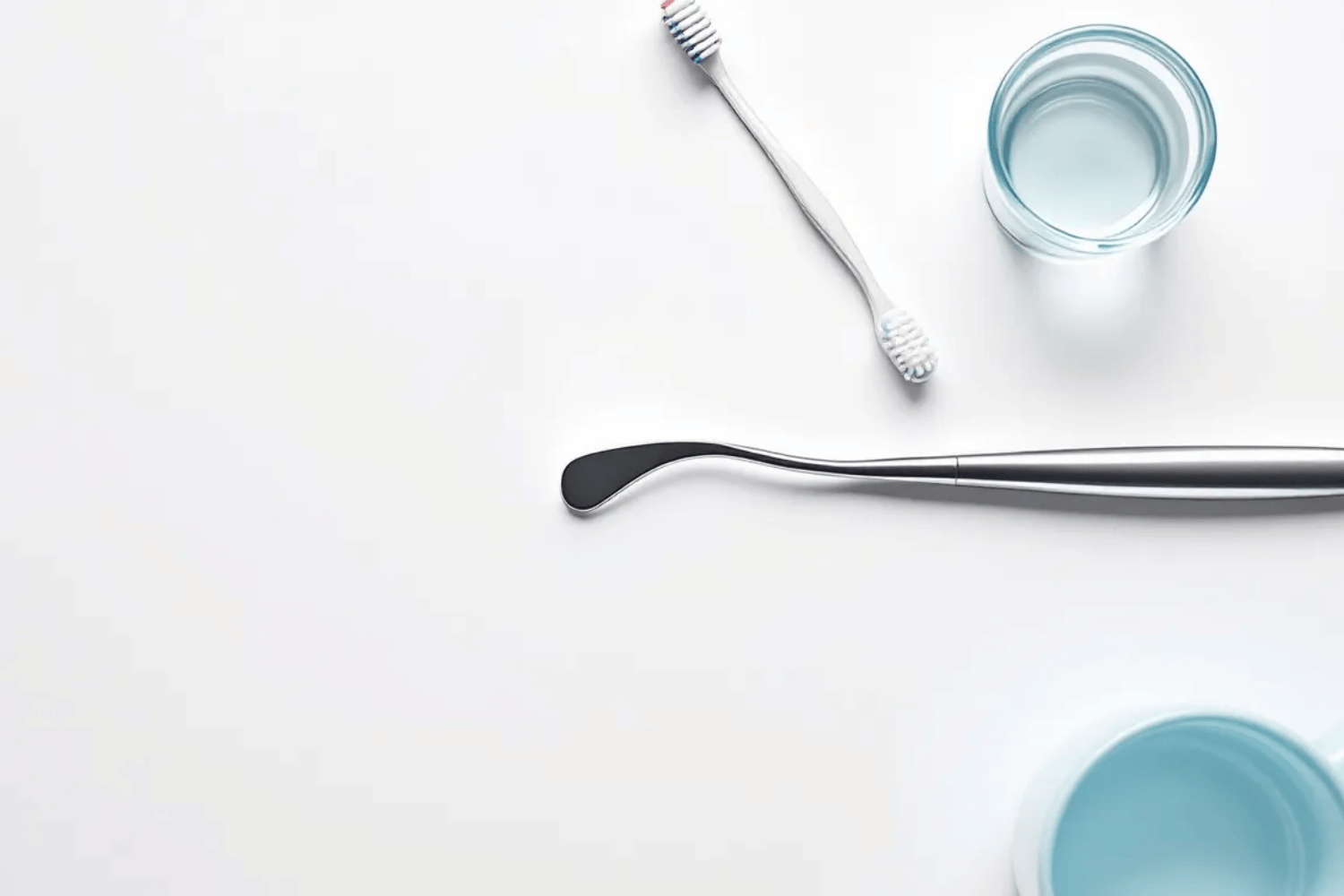 A Tongue Scraper And Various Oral Hygiene Tools Are Neatly Arranged On A Clean Surface, Emphasizing The Importance Of Maintaining Good Oral Hygiene To Prevent Issues Such As Bad Breath Or Tongue Discoloration. These Tools Can Help Improve Overall Oral Health And Address Conditions Like A White Tongue Or Black Hairy Tongue.