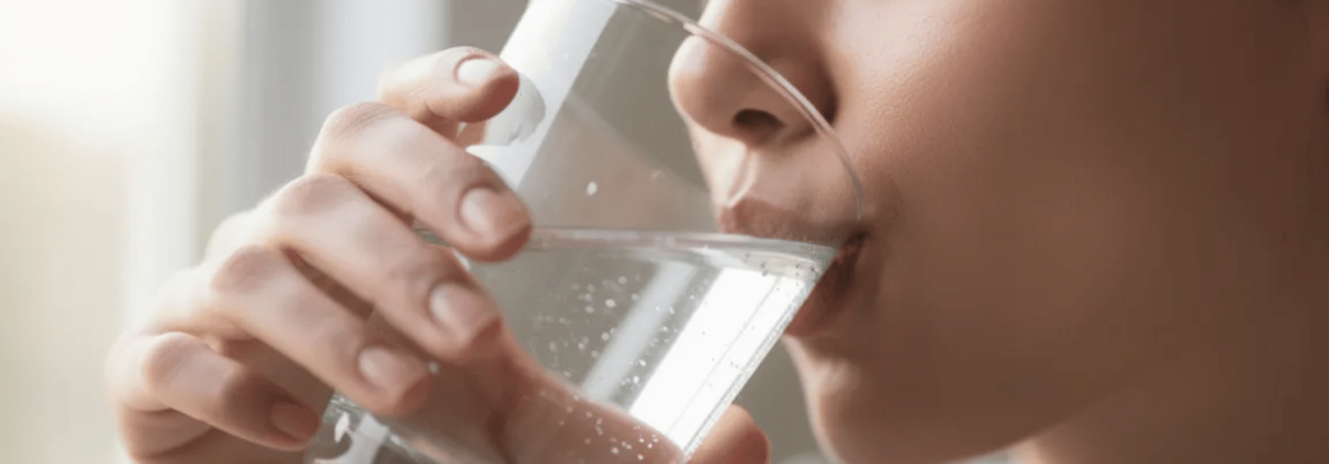 A Close-Up Image Shows A Person Drinking A Glass Of Water, Emphasizing The Importance Of Hydration For Maintaining Good Oral Health, Especially For People With Diabetes. Staying Hydrated Can Help Prevent Gum Disease And Support Overall Health By Aiding In Blood Sugar Control.