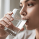 A Close-Up Image Shows A Person Drinking A Glass Of Water, Emphasizing The Importance Of Hydration For Maintaining Good Oral Health, Especially For People With Diabetes. Staying Hydrated Can Help Prevent Gum Disease And Support Overall Health By Aiding In Blood Sugar Control.