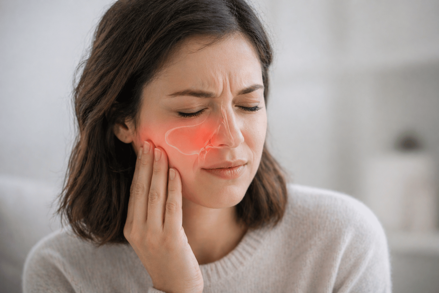 Person With Sinus Pressure Highlighting Cheek Area, Showing Sinus Infection Related Tooth Pain